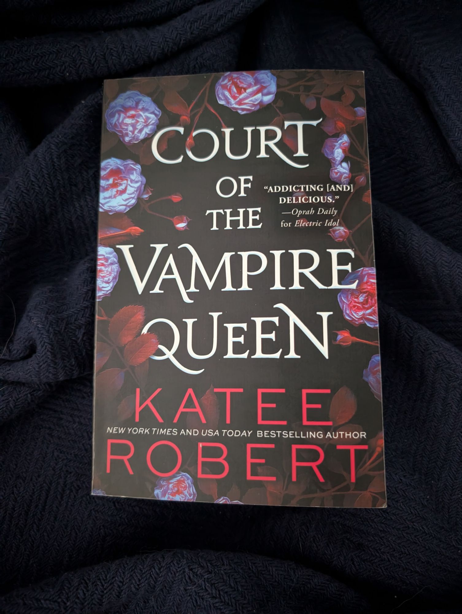 This is the cover for Court of the Vampire Queen by Katee Robert, on a dark coloured blanket
