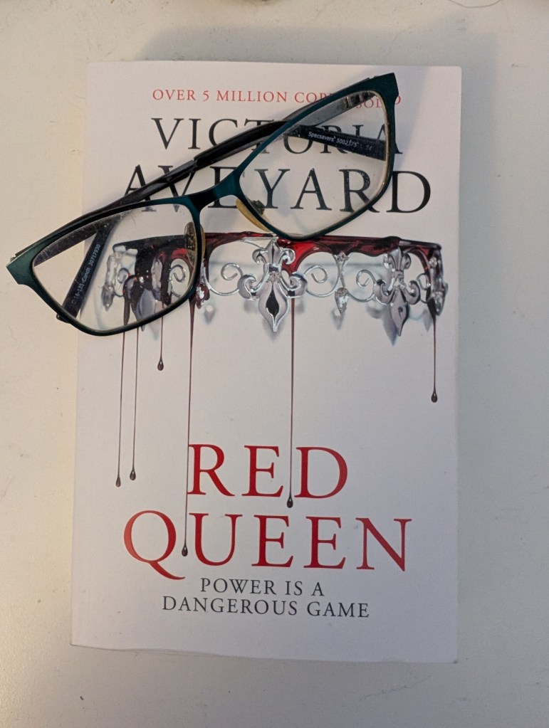 The cover for Red Queen with my glasses sitting on top of it. This is the closing picture to my final comments review